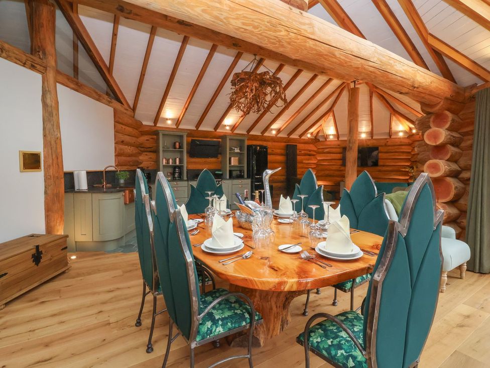 A dining room with a large table and chairs at Copper Suite in Chulmleigh