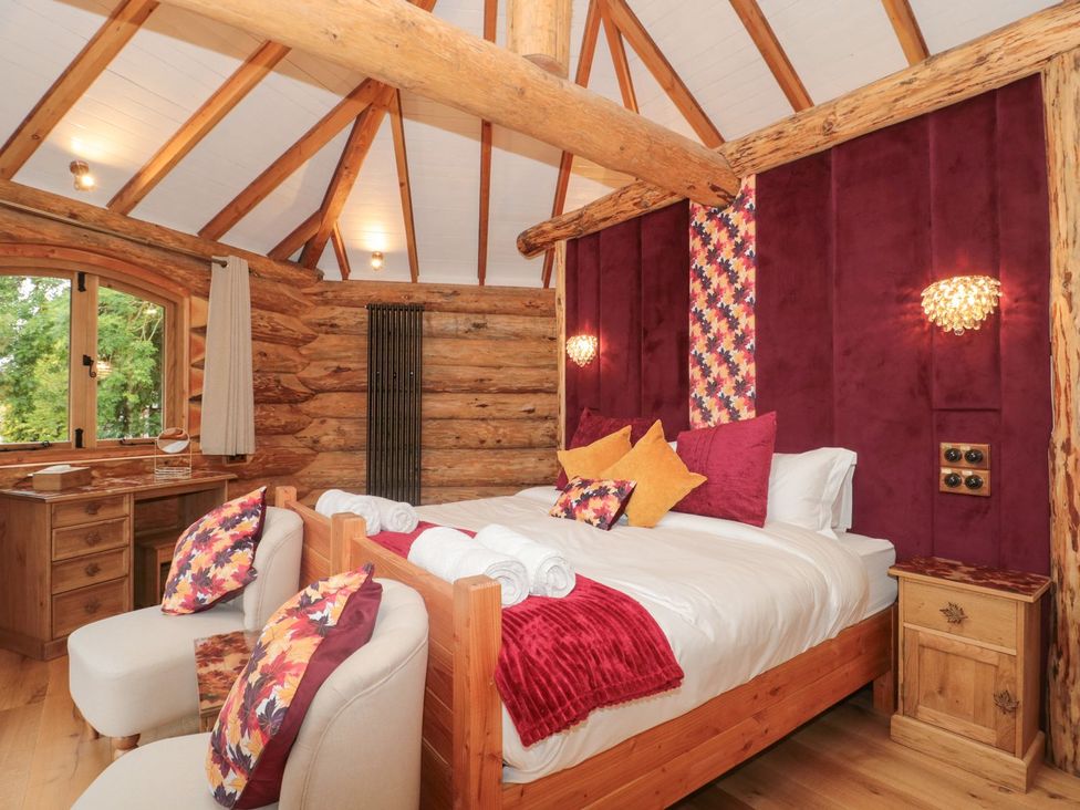 A bedroom featuring a bed with pillows and table at Copper Suite in Chulmleigh