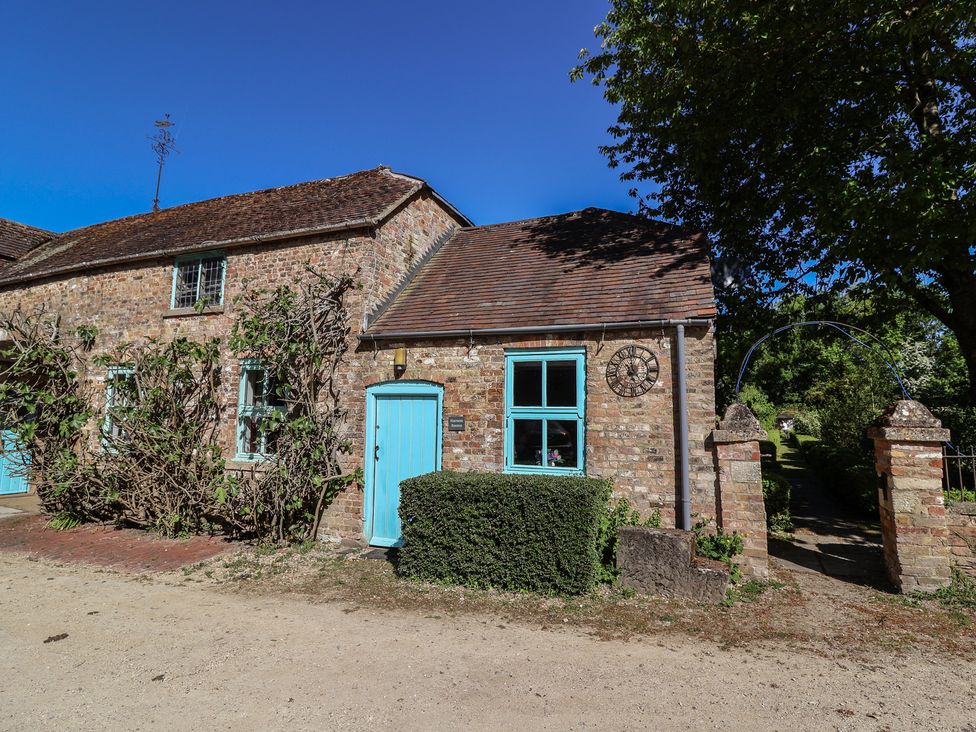 A cottage with blue door and windows at Harness Rooms in Gloucester
