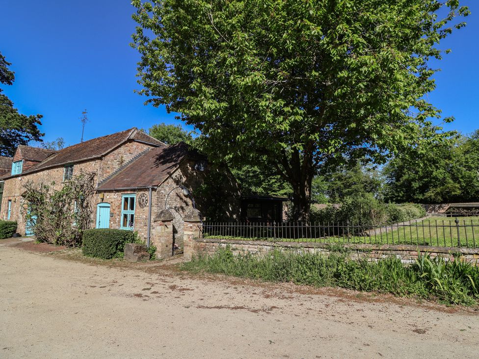 A building with a tree and garden at Harness Rooms Gloucester