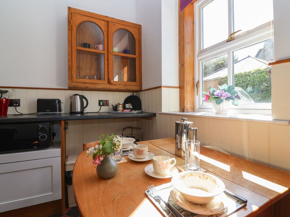 A kitchen with dining table and cooking appliances at Harness Rooms in Gloucester