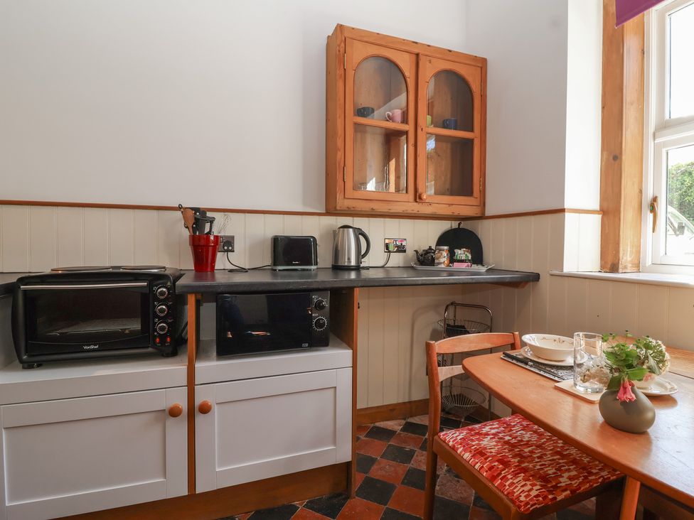 A kitchen with a table and chairs at Harness Rooms in Gloucester