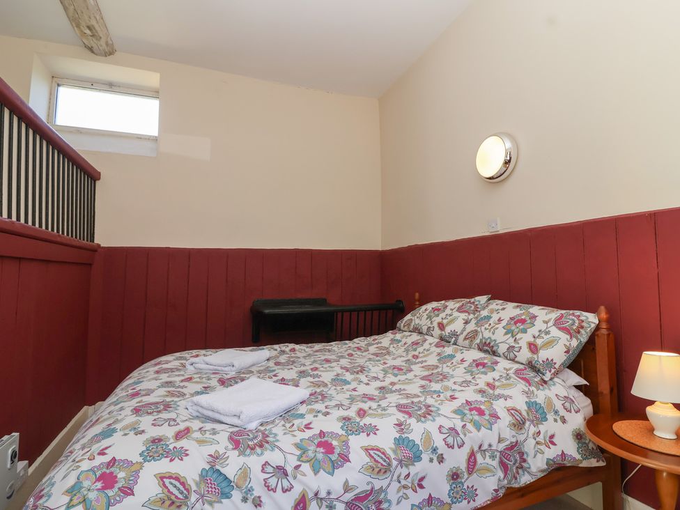 A bedroom with a bed and bedside table at Harness Rooms in Gloucester