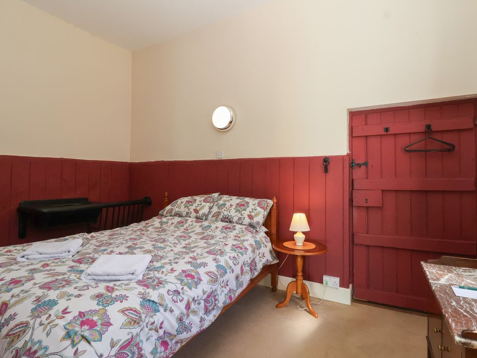 A bedroom with a bed and bedside table at Harness Rooms Gloucester