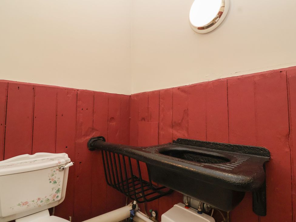 A bathroom with a toilet and a sink at Harness Rooms in Gloucester