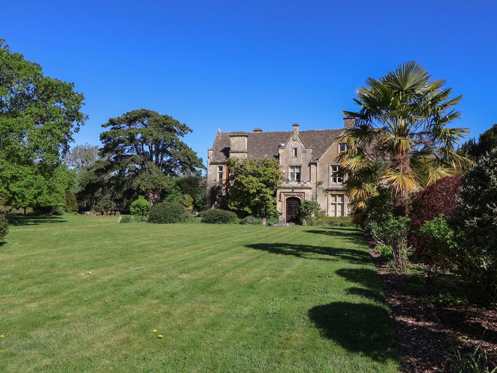 A house with a garden and trees at Harness Rooms Gloucester