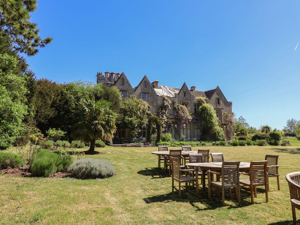 A house with tables and chairs in the garden at Harness Rooms Gloucester