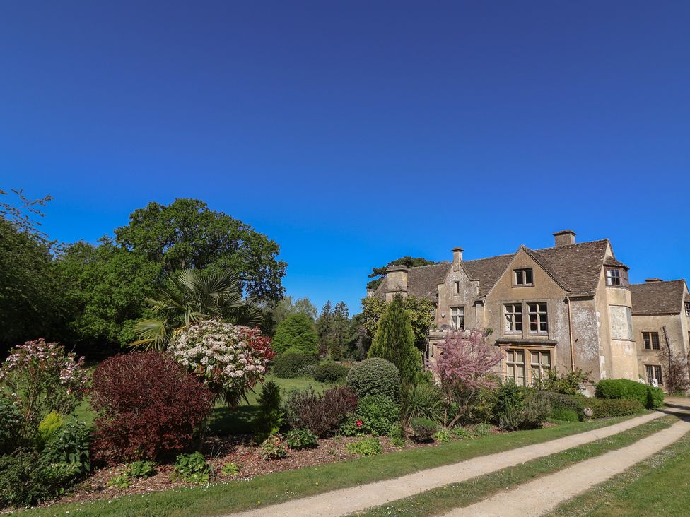 A house surrounded by a garden with a pathway at Harness Rooms in Gloucester