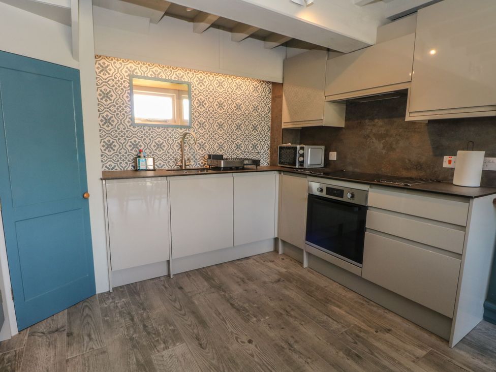 A kitchen with cabinets and appliances at Pearls Farm Two in Wildboarclough near Macclesfield