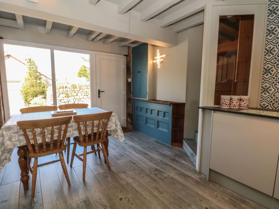A dining room with a table and chairs at Pearls Farm Two in Wildboarclough near Macclesfield