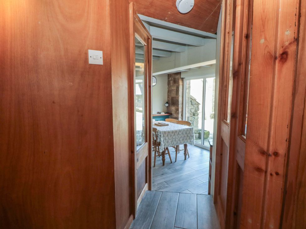 A hallway leading to a dining room with a table and chairs at Pearls Farm Two Wildboarclough near Macclesfield