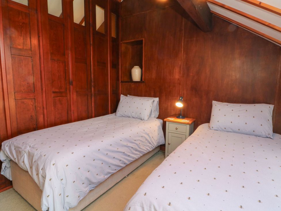 A bedroom with two beds and a nightstand at Pearls Farm Two Wildboarclough near Macclesfield