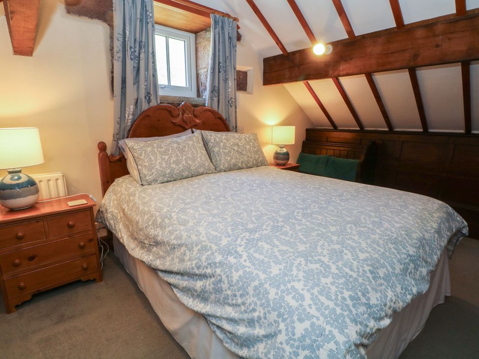 A bedroom with a bed and bedside table at Pearls Farm Two in Wildboarclough near Macclesfield