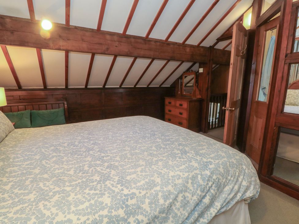 A bedroom with a bed and wooden furniture at Pearls Farm Two Wildboarclough near Macclesfield