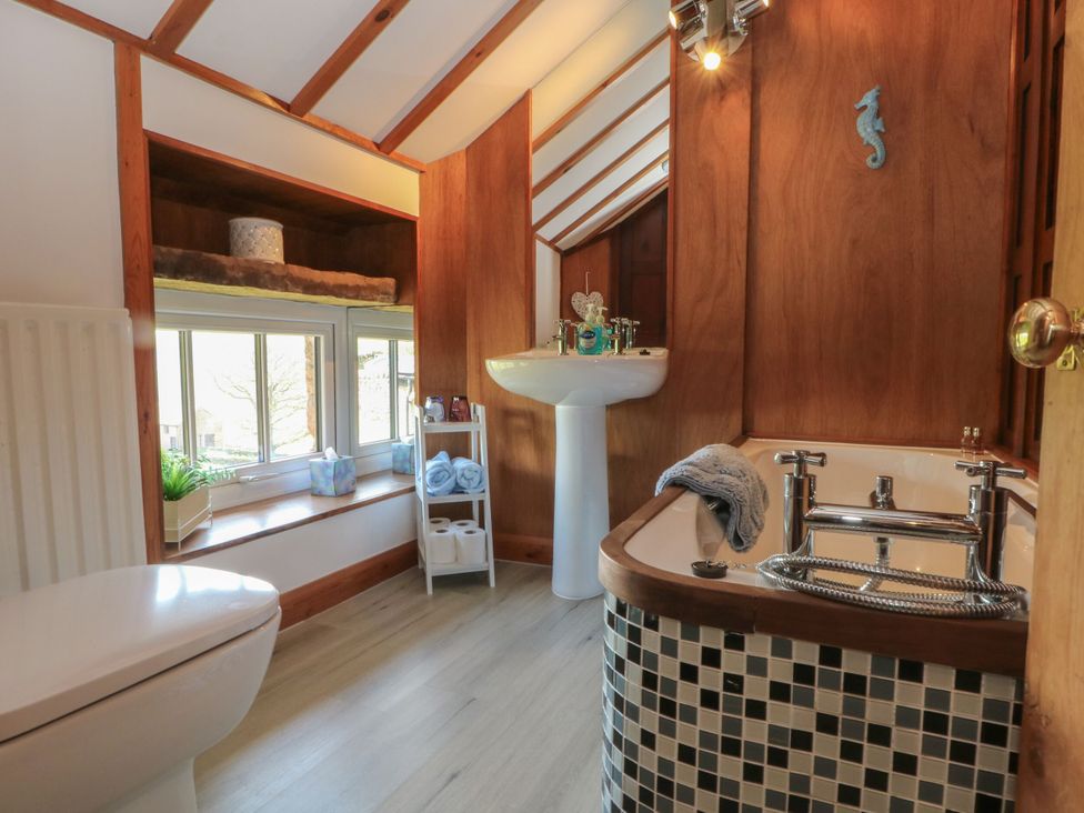 A bathroom with a bathtub and wash basin at Pearls Farm Two in Wildboarclough near Macclesfield