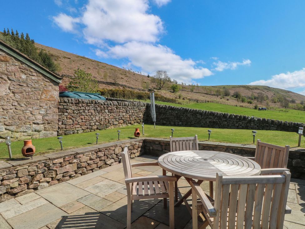 An outdoor sitting area with a table and chairs at Pearls Farm Two Wildboarclough near Macclesfield