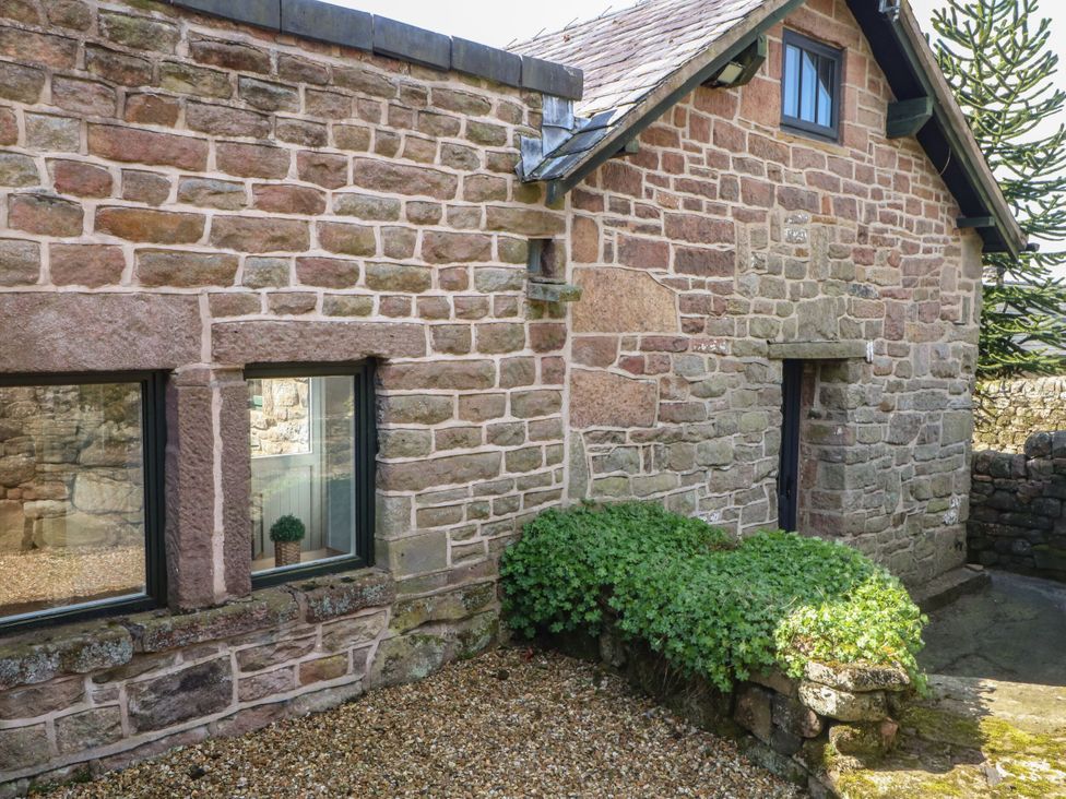 An exterior view of a stone cottage with windows at Pearls Farm Two in Wildboarclough near Macclesfield
