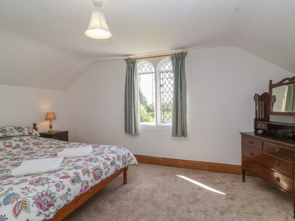 A bedroom with a bed and a dresser at The Lodge in Gloucester