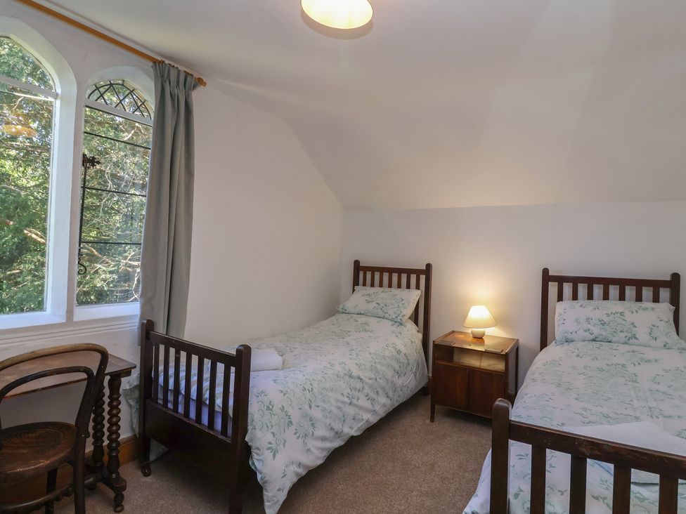 A bedroom with two beds and a window at The Lodge in Gloucester
