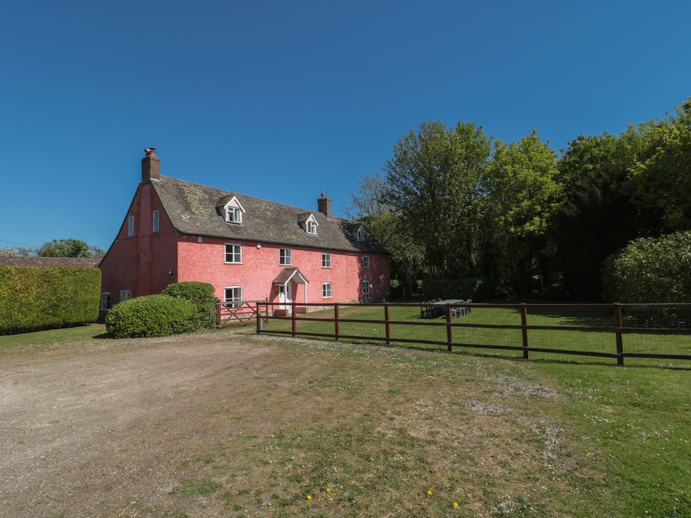 A house with a garden and fence at Walk Farmhouse in Gloucester