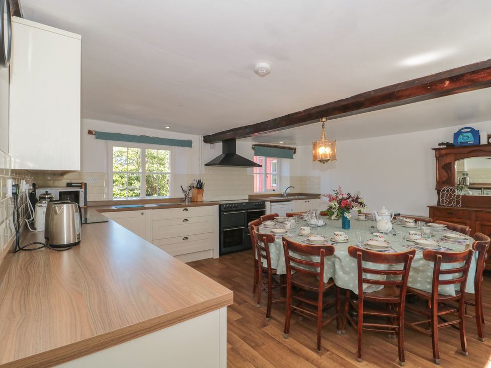A kitchen with a dining table set for a meal at Walk Farmhouse, Gloucester