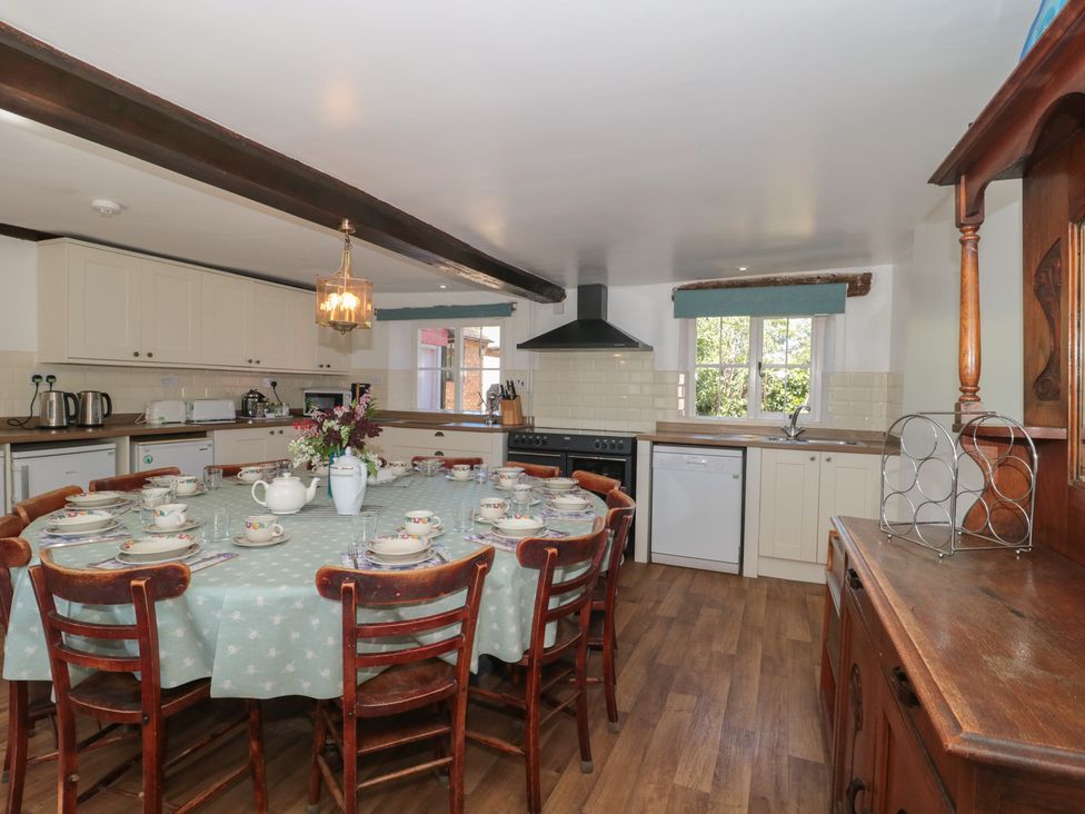 A kitchen with a dining table and chairs at Walk Farmhouse in Gloucester
