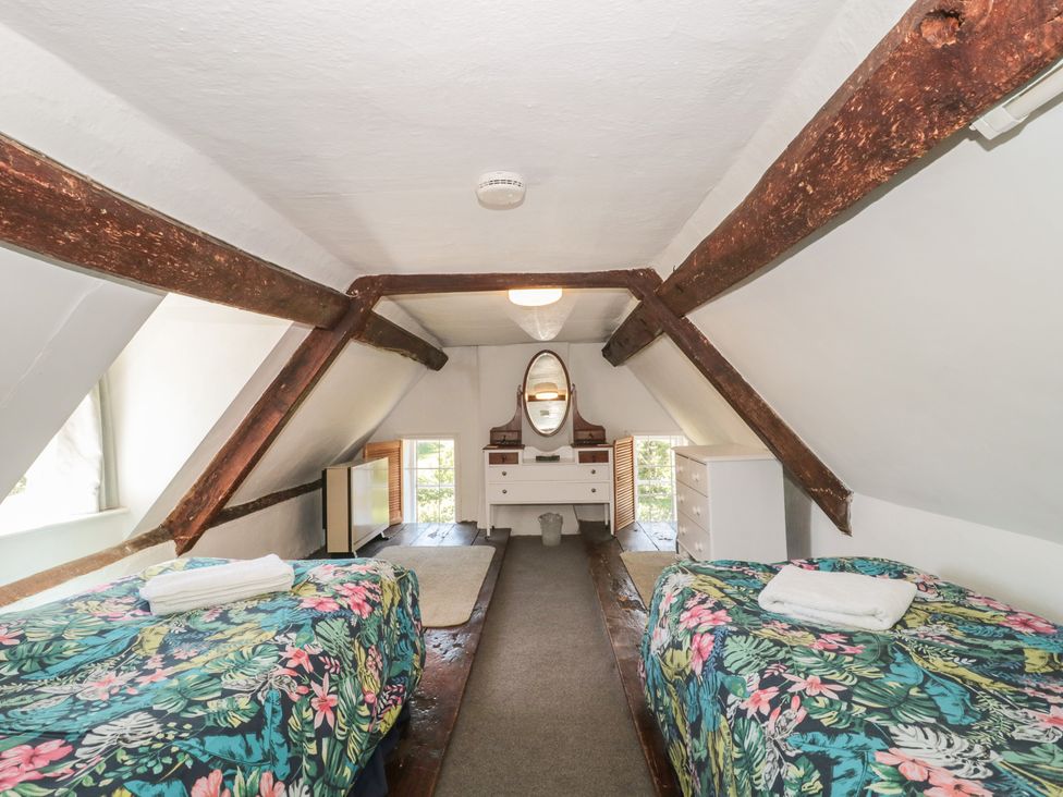 A bedroom with two beds and a dresser at Walk Farmhouse in Gloucester