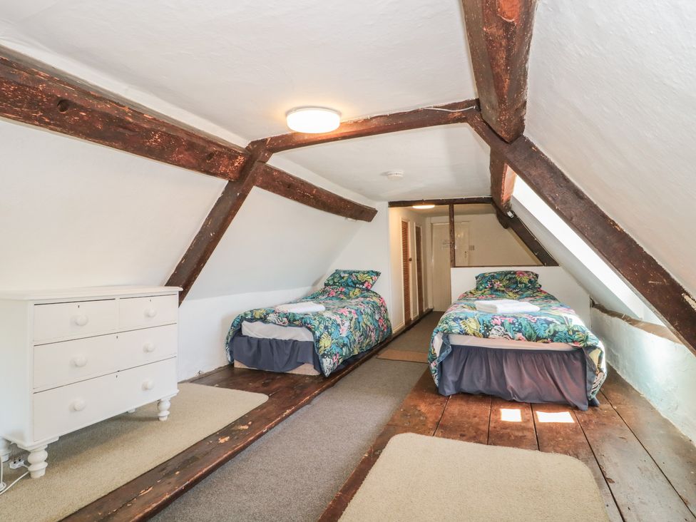 A bedroom with two beds and a dresser at Walk Farmhouse in Gloucester