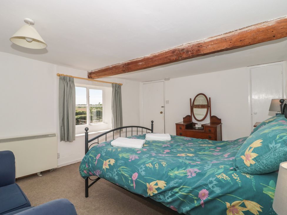 A bedroom with a bed and window at Walk Farmhouse in Gloucester