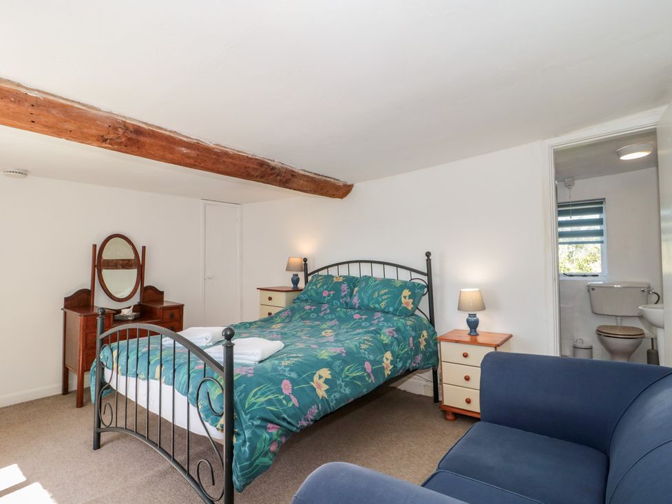 A bedroom with a bed and nightstand at Walk Farmhouse in Gloucester