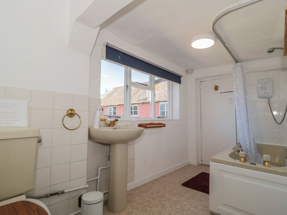 A bathroom with a sink and bathtub at Walk Farmhouse in Gloucester