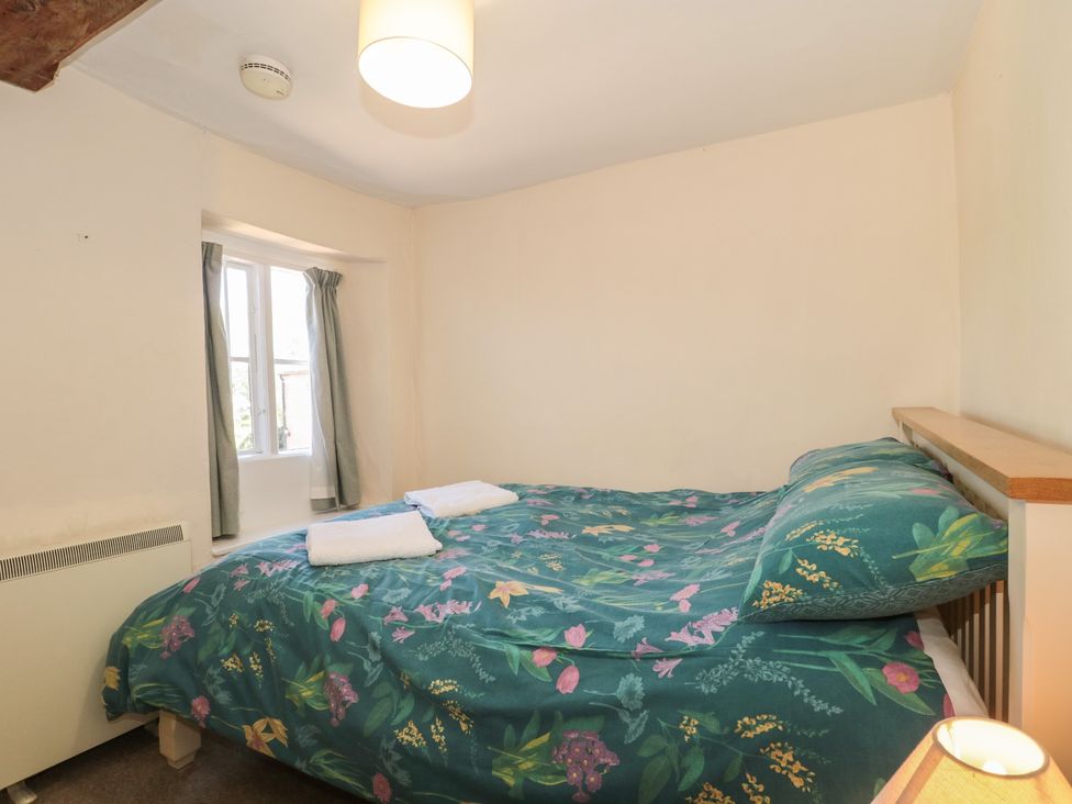 A bedroom with a bed and window at Walk Farmhouse in Gloucester