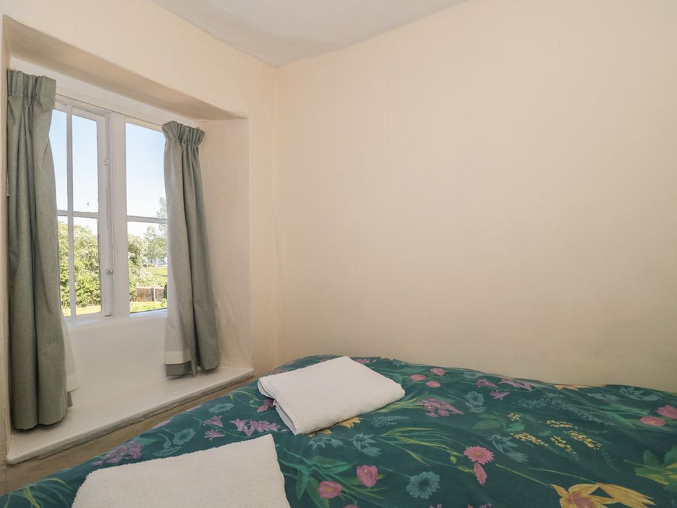 A bedroom with a bed and window at Walk Farmhouse in Gloucester