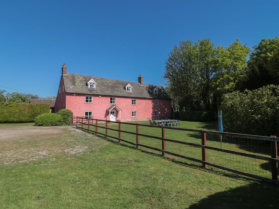 A house with a garden and seating area at Walk Farmhouse in Gloucester