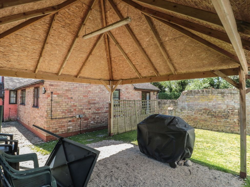 An outdoor area with a shelter and grill cover at Walk Farmhouse in Whitminster