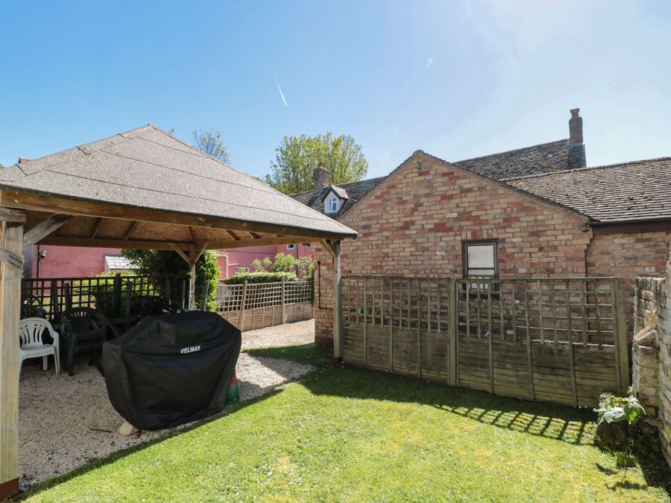 A garden with a gazebo and grass area at Walk Farmhouse in Whitminster