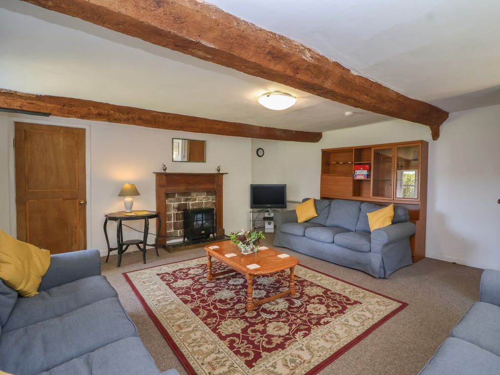 A living room with sofas and a fireplace at Walk House in Gloucester