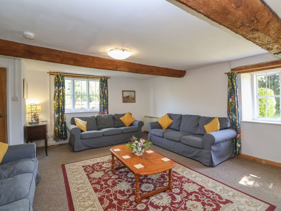 A living room with sofas and a table at Walk House in Gloucester