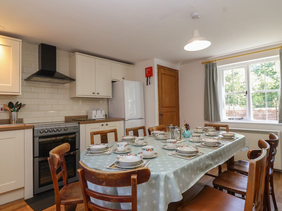 A kitchen with a dining table set for meal at Walk House in Gloucester