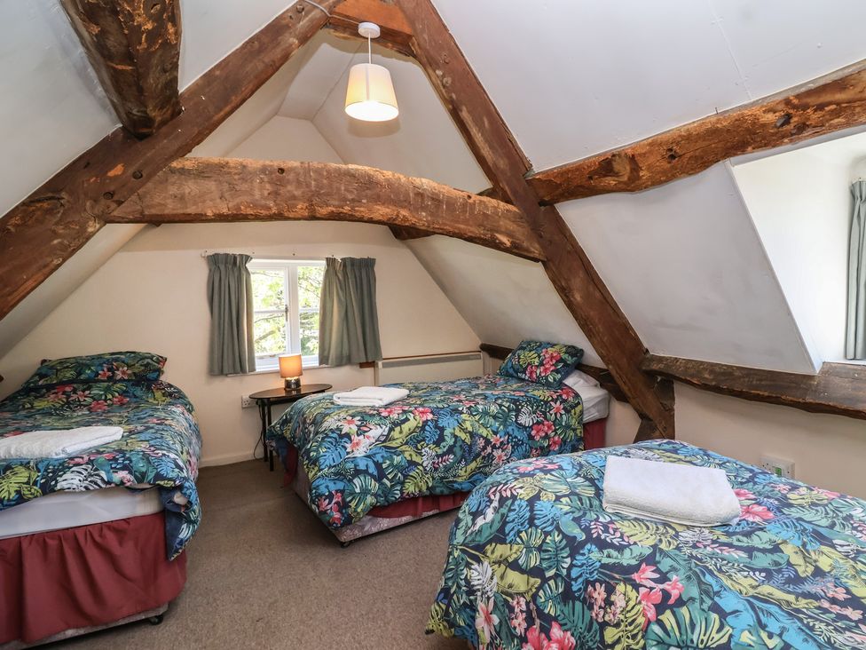 A bedroom with three beds at Walk House in Gloucester