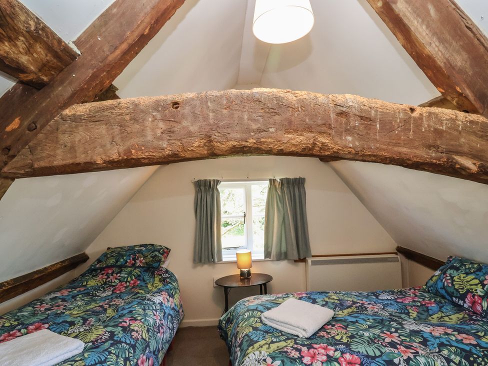 A bedroom with two beds and a window at Walk House in Gloucester