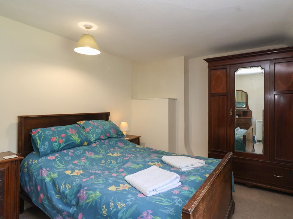 A bedroom with a bed and wardrobe at Walk House, Gloucester