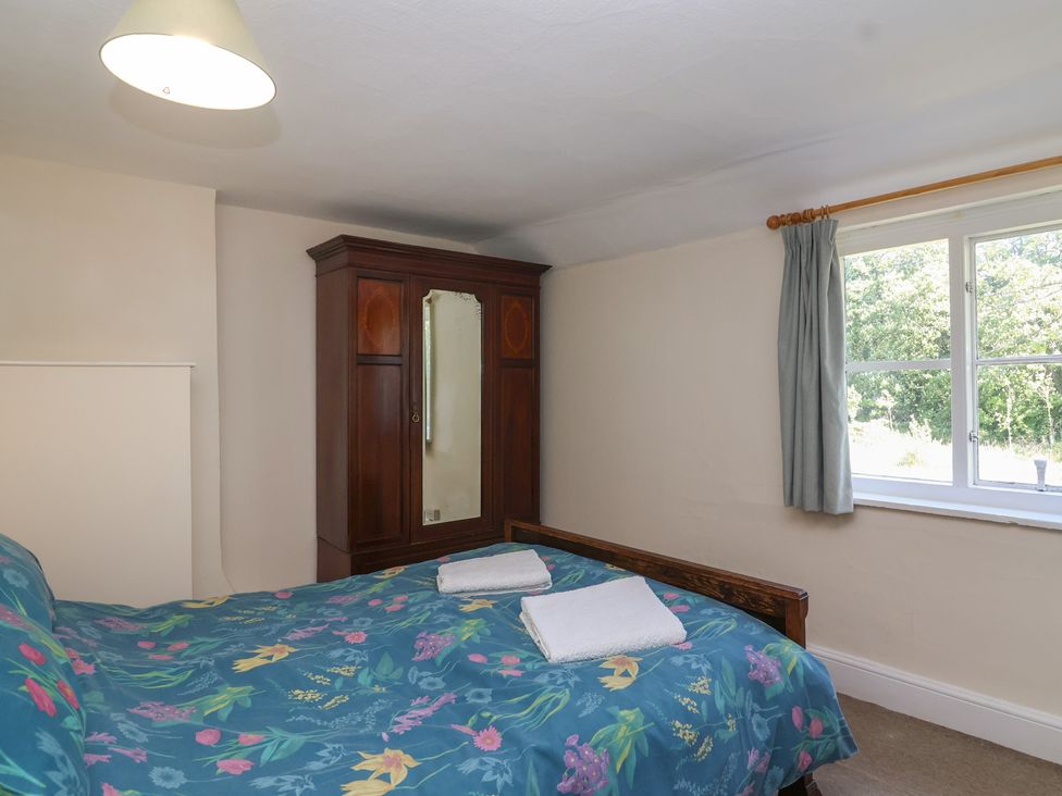 A bedroom with a bed and wardrobe at Walk House in Gloucester