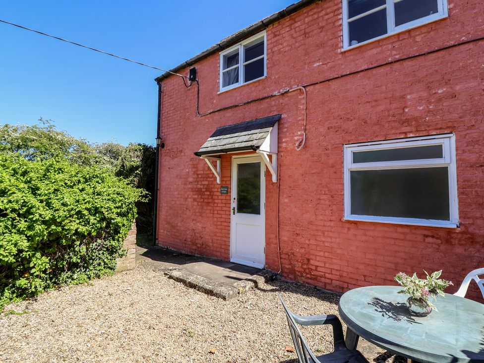 An exterior view of a house with a garden at Walk Farm Cottage in Gloucester