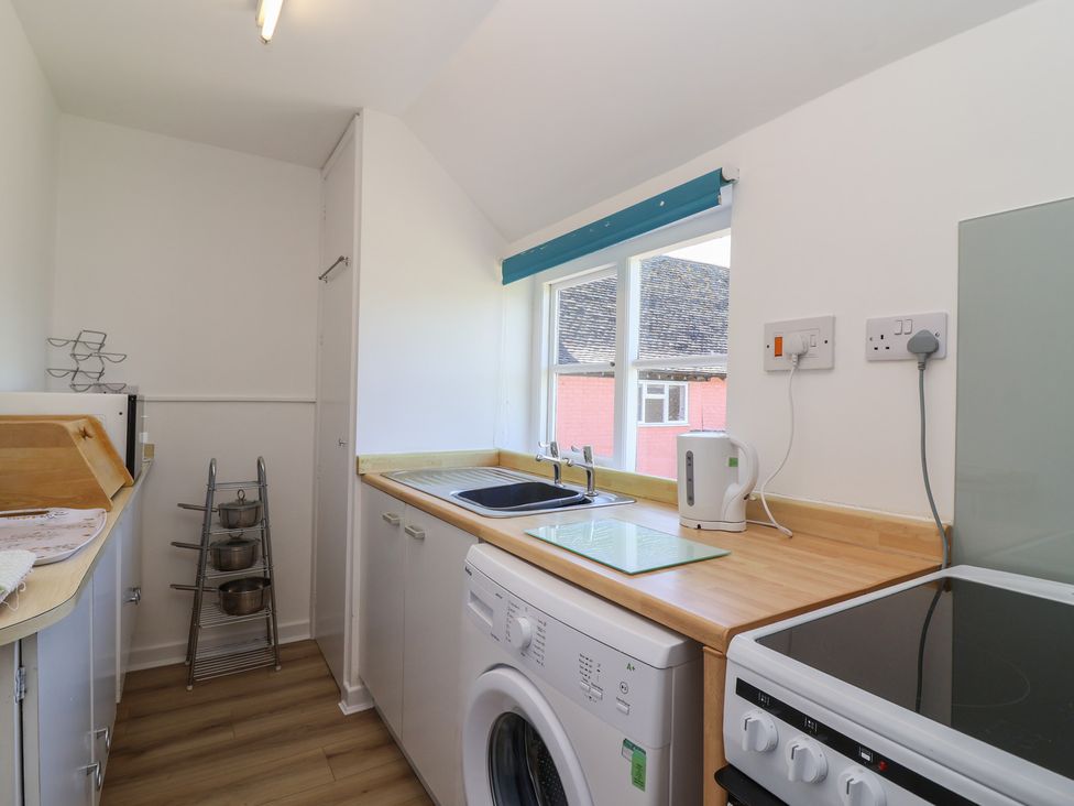 A kitchen with sink and appliances at Walk Farm Cottage in Gloucester