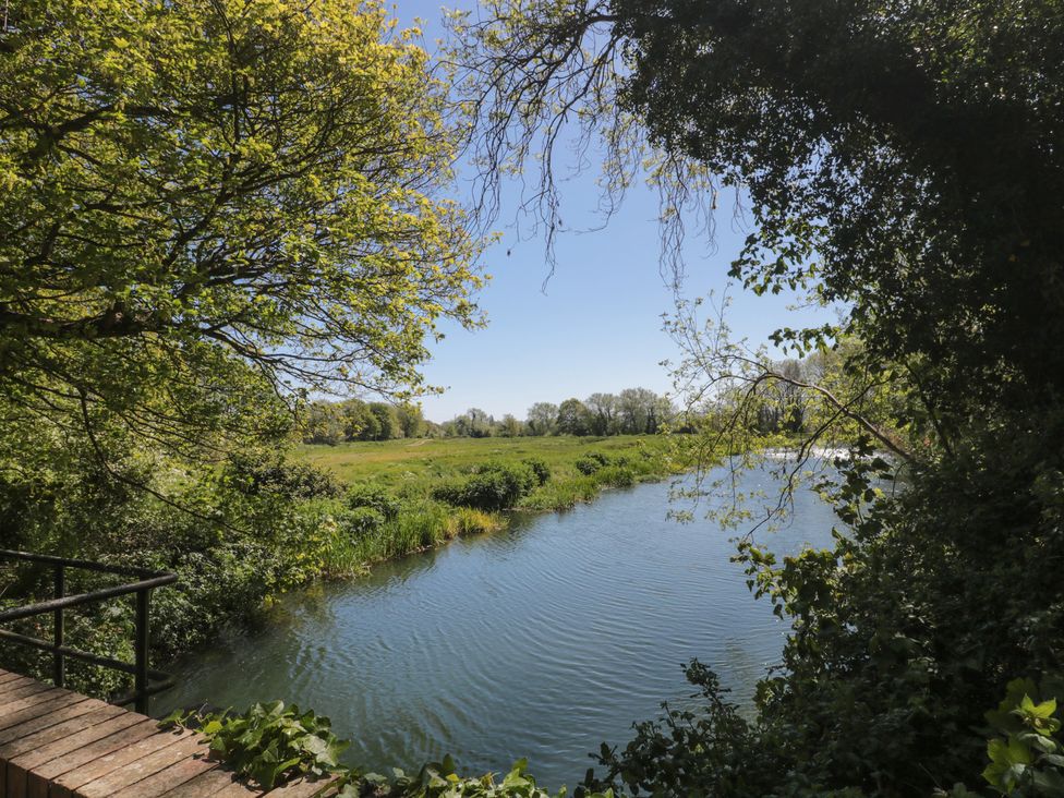 A river surrounded by grass and trees at Walk Farm Cottage in Gloucester