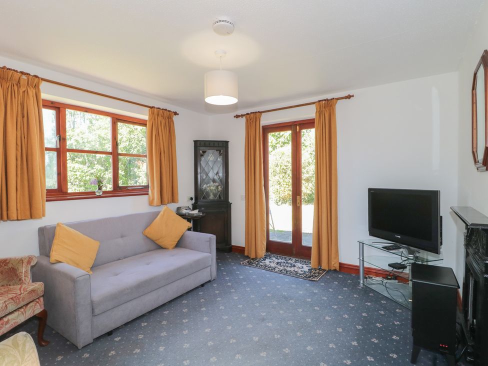 A living room with a sofa and television at Walk Close in Gloucester