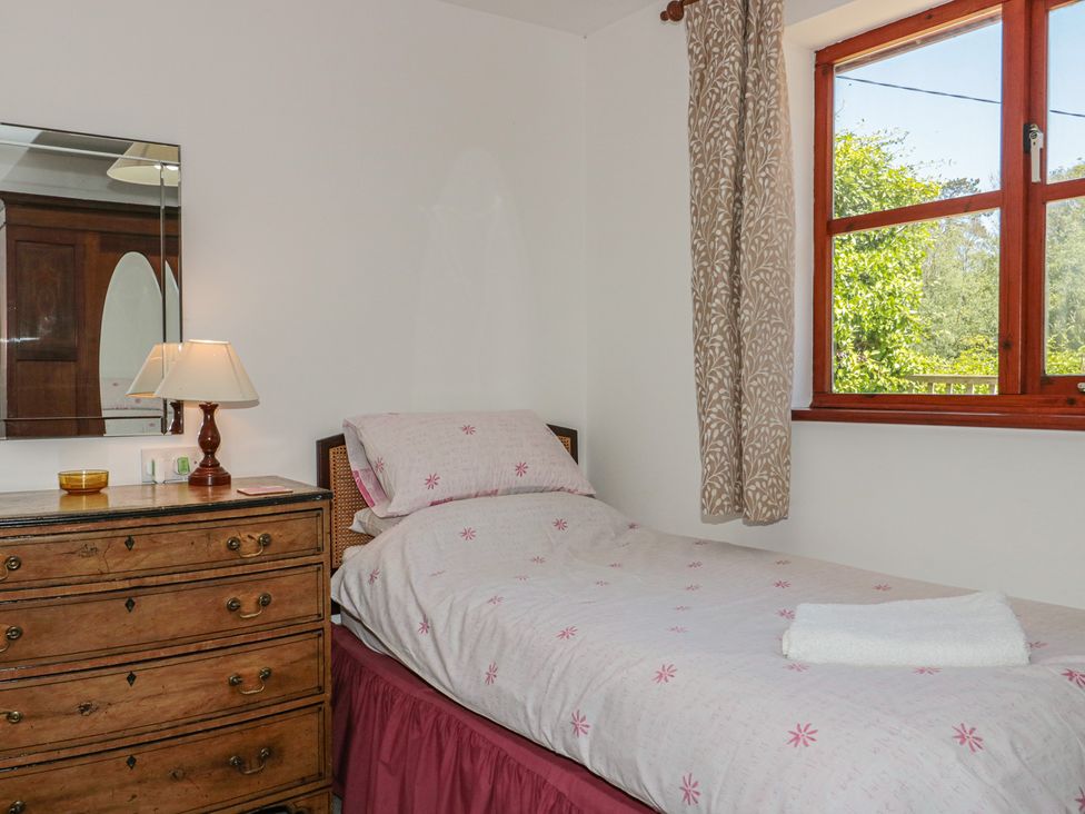 A bedroom with a single bed and mirror at Walk Close in Gloucester