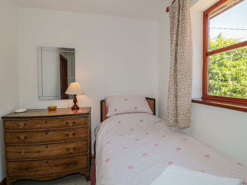 A bedroom with a single bed and wooden furniture at Walk Close in Gloucester