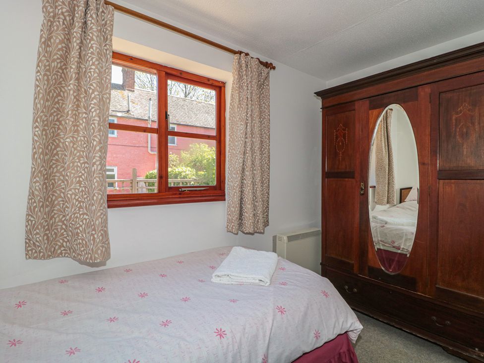 A bedroom with a bed and wardrobe at Walk Close in Gloucester